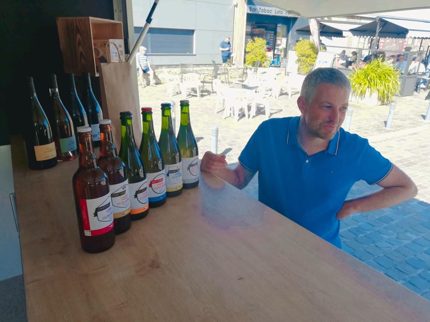 François derrière son comptoir, ses cuvées alignées